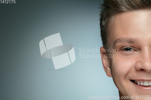 Image of Close-up portrait of young man isolated on grey studio background