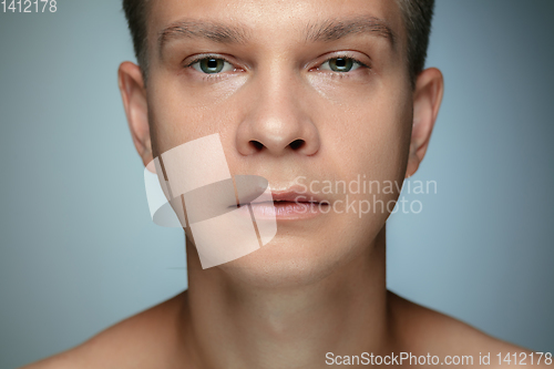 Image of Portrait of shirtless young man isolated on grey studio background