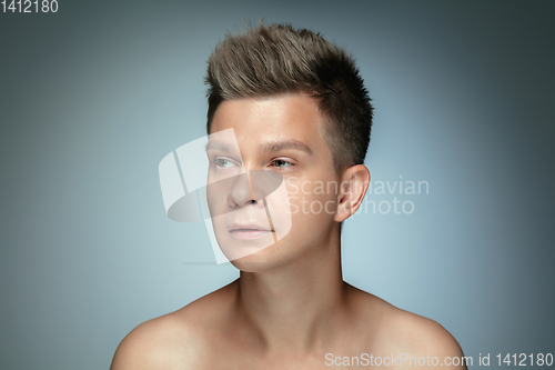 Image of Portrait of shirtless young man isolated on grey studio background