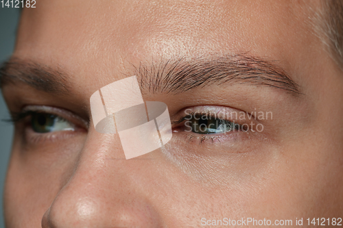 Image of Close-up portrait of young man isolated on grey studio background