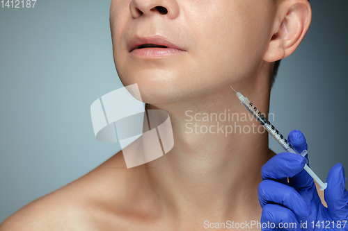 Image of Close-up portrait of young man isolated on grey studio background