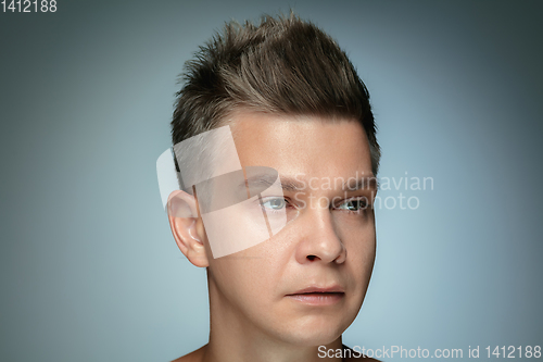 Image of Portrait of shirtless young man isolated on grey studio background