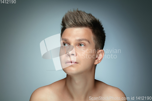 Image of Portrait of shirtless young man isolated on grey studio background