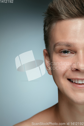 Image of Close-up portrait of young man isolated on grey studio background