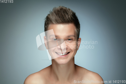 Image of Portrait of shirtless young man isolated on grey studio background