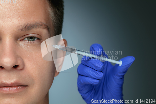 Image of Close-up portrait of young man isolated on grey studio background