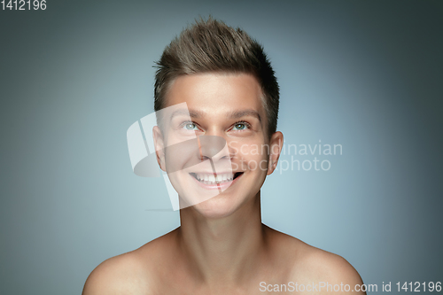 Image of Portrait of shirtless young man isolated on grey studio background