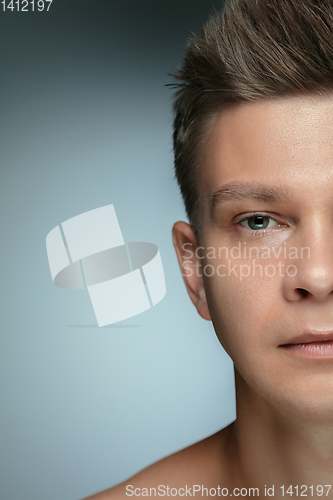 Image of Close-up portrait of young man isolated on grey studio background