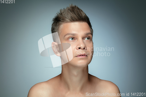 Image of Portrait of shirtless young man isolated on grey studio background