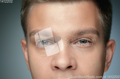 Image of Close-up portrait of young man isolated on grey studio background