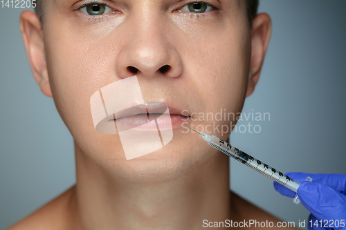 Image of Close-up portrait of young man isolated on grey studio background