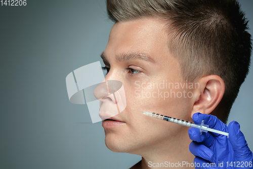 Image of Close-up portrait of young man isolated on grey studio background