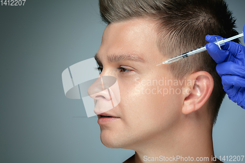 Image of Close-up portrait of young man isolated on grey studio background