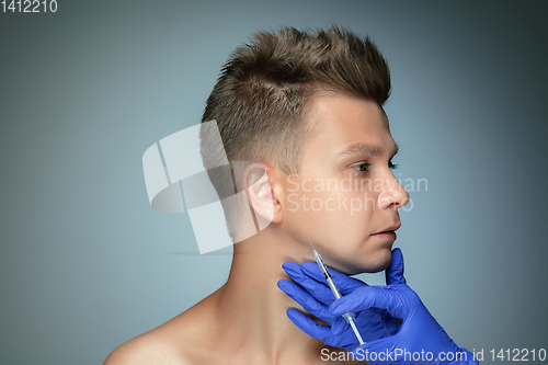 Image of Close-up portrait of young man isolated on grey studio background