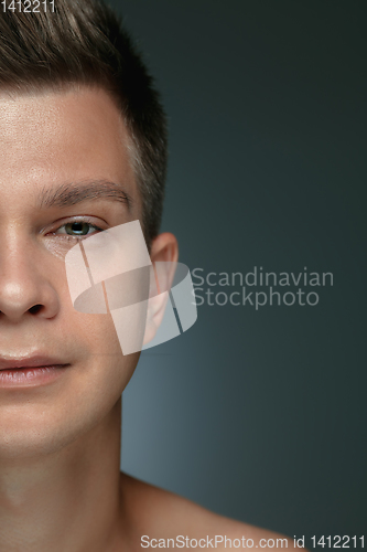 Image of Close-up portrait of young man isolated on grey studio background