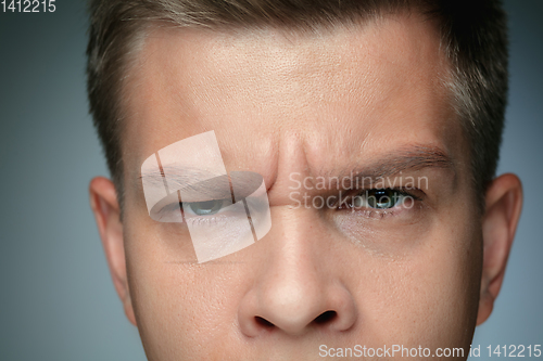 Image of Close-up portrait of young man isolated on grey studio background