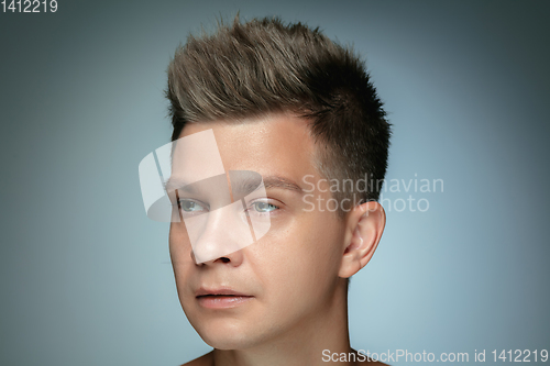 Image of Portrait of shirtless young man isolated on grey studio background