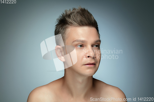 Image of Portrait of shirtless young man isolated on grey studio background