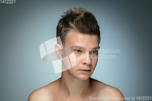 Image of Portrait of shirtless young man isolated on grey studio background