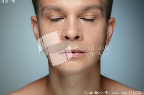 Image of Portrait of shirtless young man isolated on grey studio background