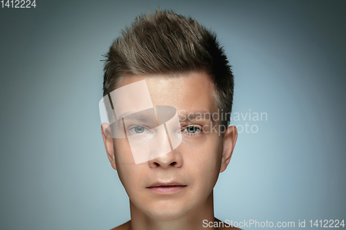 Image of Portrait of shirtless young man isolated on grey studio background