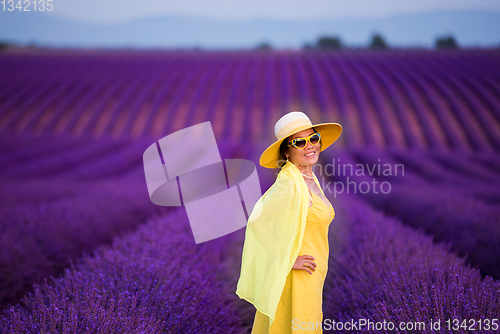 Image of asian woman in yellow dress and hat at lavender field