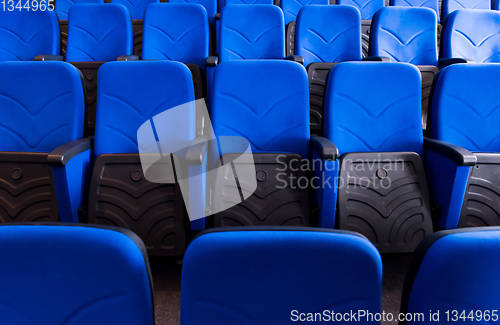 Image of hall with rows of blue seats