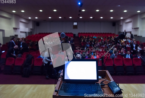 Image of laptop computer and microphone at podium