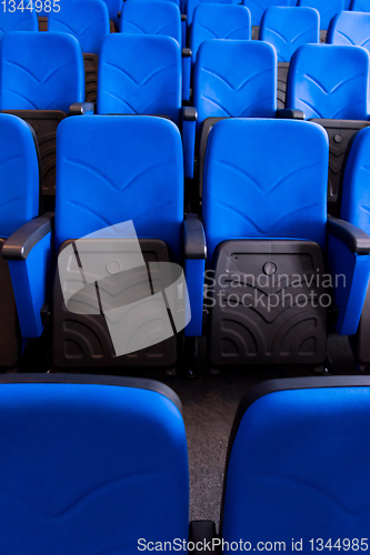 Image of hall with rows of blue seats