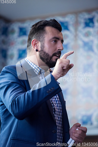 Image of successful businessman giving presentations at conference room