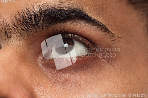 Image of Close up portrait of young man on blue background.