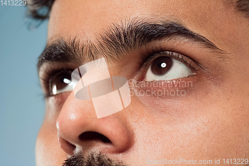 Image of Close up portrait of young man on blue background.