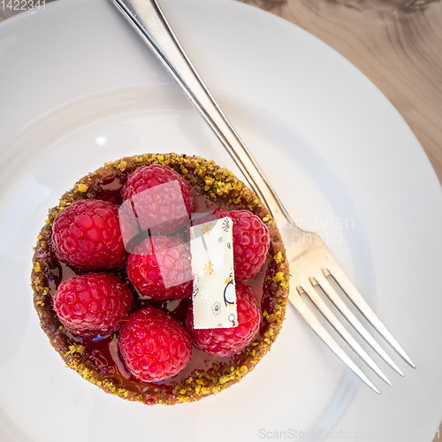 Image of sweet raspberry tart with fork