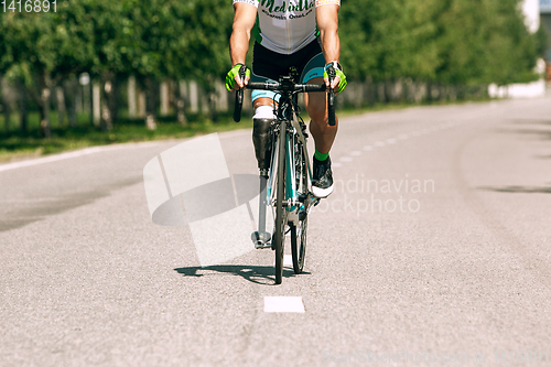 Image of Dnipro, Ukraine - July 12, 2019: athlete with disabilities or amputee training in cycling