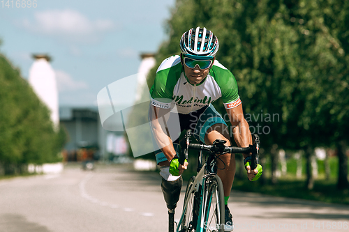 Image of Dnipro, Ukraine - July 12, 2019: athlete with disabilities or amputee training in cycling