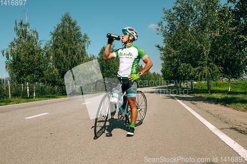 Image of Dnipro, Ukraine - July 12, 2019: athlete with disabilities or amputee training in cycling