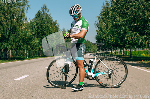 Image of Dnipro, Ukraine - July 12, 2019: athlete with disabilities or amputee training in cycling