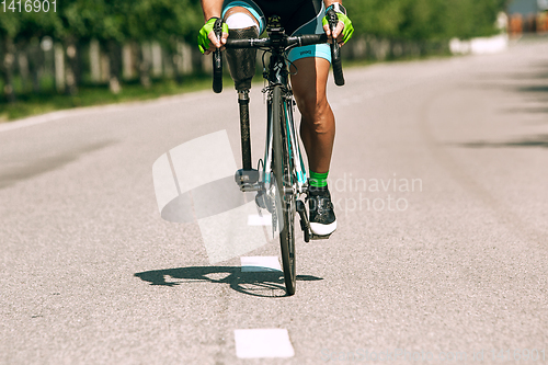 Image of Dnipro, Ukraine - July 12, 2019: athlete with disabilities or amputee training in cycling