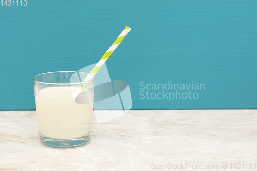 Image of Creamy, fresh milk with a straw in a glass