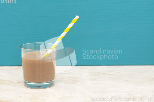 Image of Thick chocolate milkshake with a straw in a glass