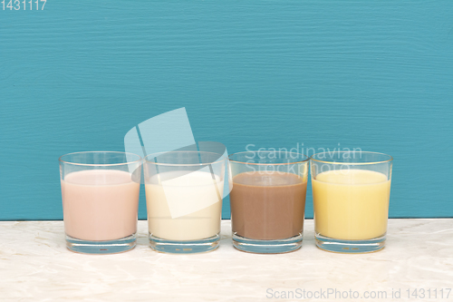 Image of Flavoured milkshakes and fresh creamy milk in glass tumblers