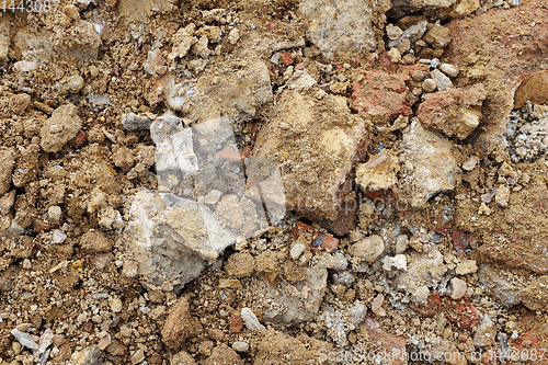Image of Rough broken concrete and brick, mixed with soil and stones