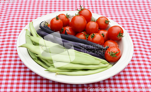 Image of Green yin yang beans, purple French beans and juicy tomatoes 