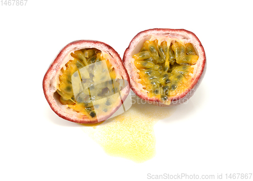 Image of Passion fruit cut in half showing yellow pulp around seeds