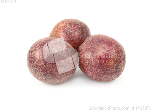 Image of Three whole passion fruits with speckled purple skins