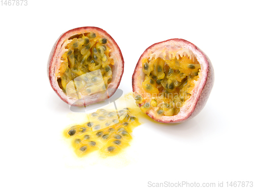 Image of Passion fruit cut in half with juicy yellow pulp and seeds