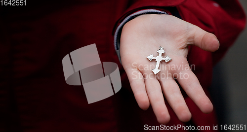 Image of Cross in child hands 