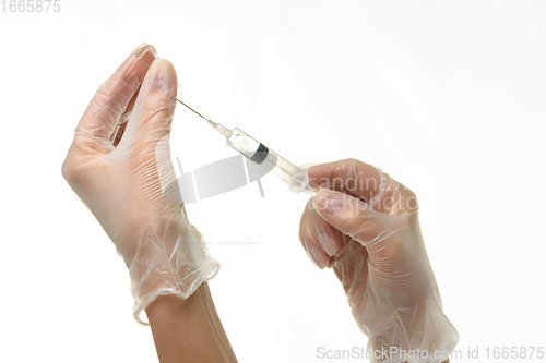 Image of Doctor\'s hands take medicine with a syringe from an ampoule