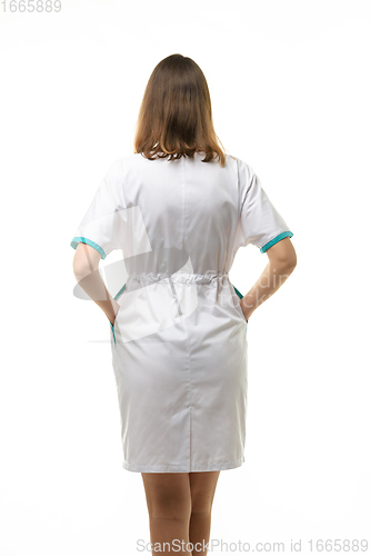 Image of Girl in a white medical coat, view from the back, isolated on a white background