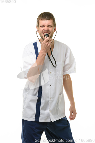 Image of Irritated doctor yelling into phonendoscope head and looking into frame isolated on white